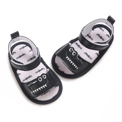 Top-down view of navy blue baby gator sandals showing the inner sole alligator pattern.