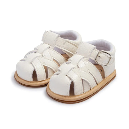 Pair of classic crisp white baby boy fisherman sandals side-by-side highlighting the infant first walker design.