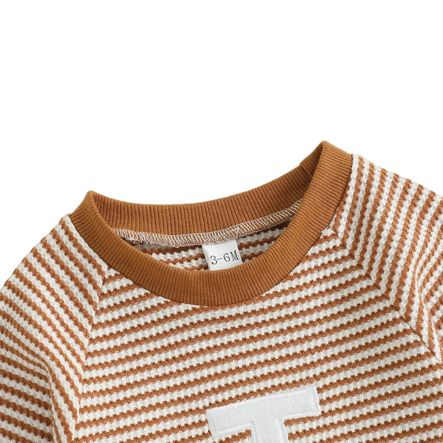 Close up of the comfortable round neckline with ribbed brown trim on the striped football baby jumpsuit.