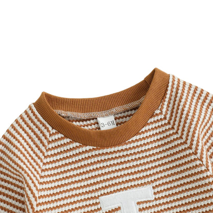 Close up of the comfortable round neckline with ribbed brown trim on the striped football baby jumpsuit.