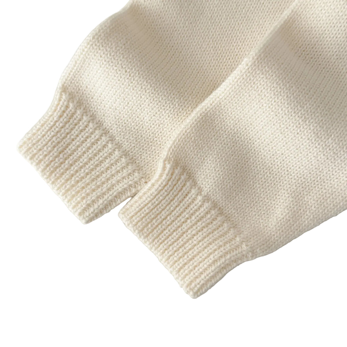 Close-up of the soft cream ribbed knit long sleeve cuffs on the baby boy formal romper.
