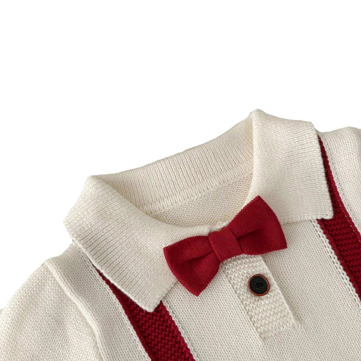 Close-up of the peter pan collar, wood-style button, and attached red knit bow tie on the baby boy Christmas romper.