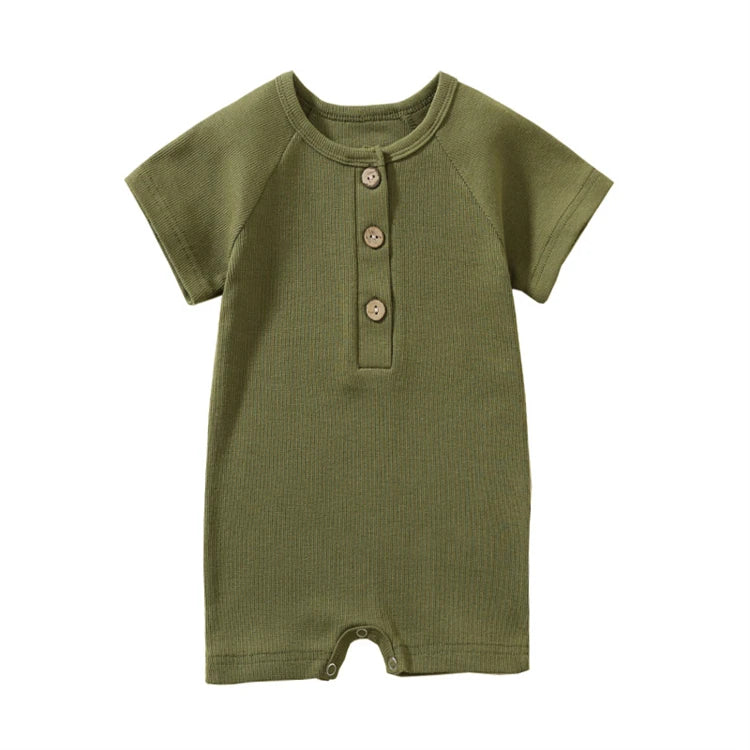 Olive green moss garden baby jumpsuit with premium stitching and natural wood details.