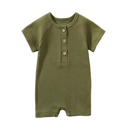 Olive green moss garden baby jumpsuit with premium stitching and natural wood details.