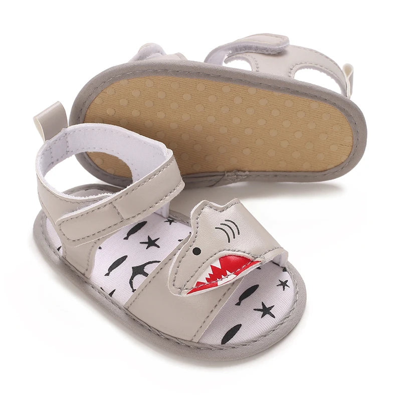 Grey infant shark sandals displaying the flexible anti-slip dotted cotton sole.