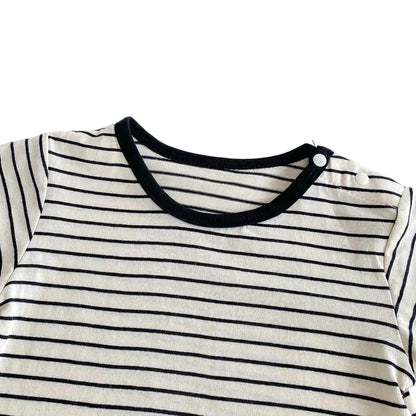 Close up of the round, black-trimmed neckline on the baby boy Breton-stripe short-sleeve t-shirt.