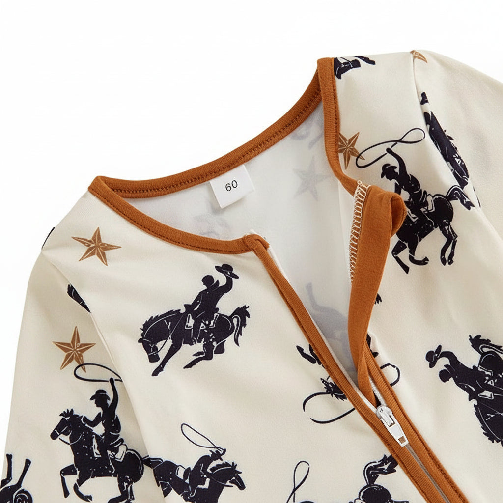 Close-up of the neckline on the infant western romper showing the zipper slightly open to reveal the protective zipper guard and contrasting brown trim.