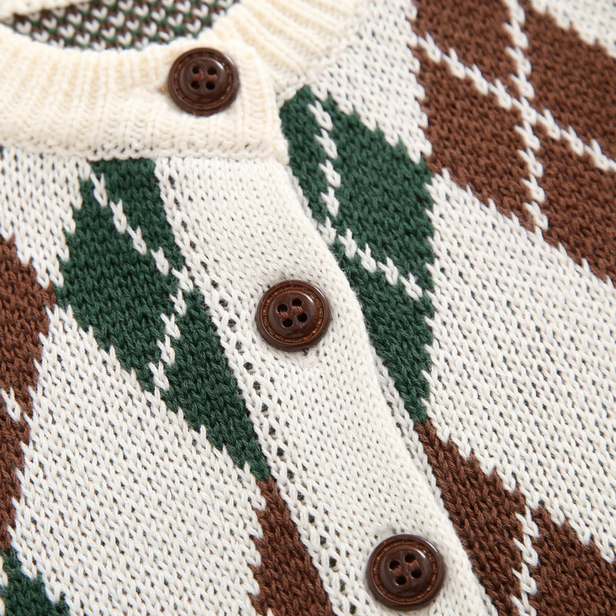 Detail view of brown front buttons and soft cotton knit pattern on toddler argyle cardigan