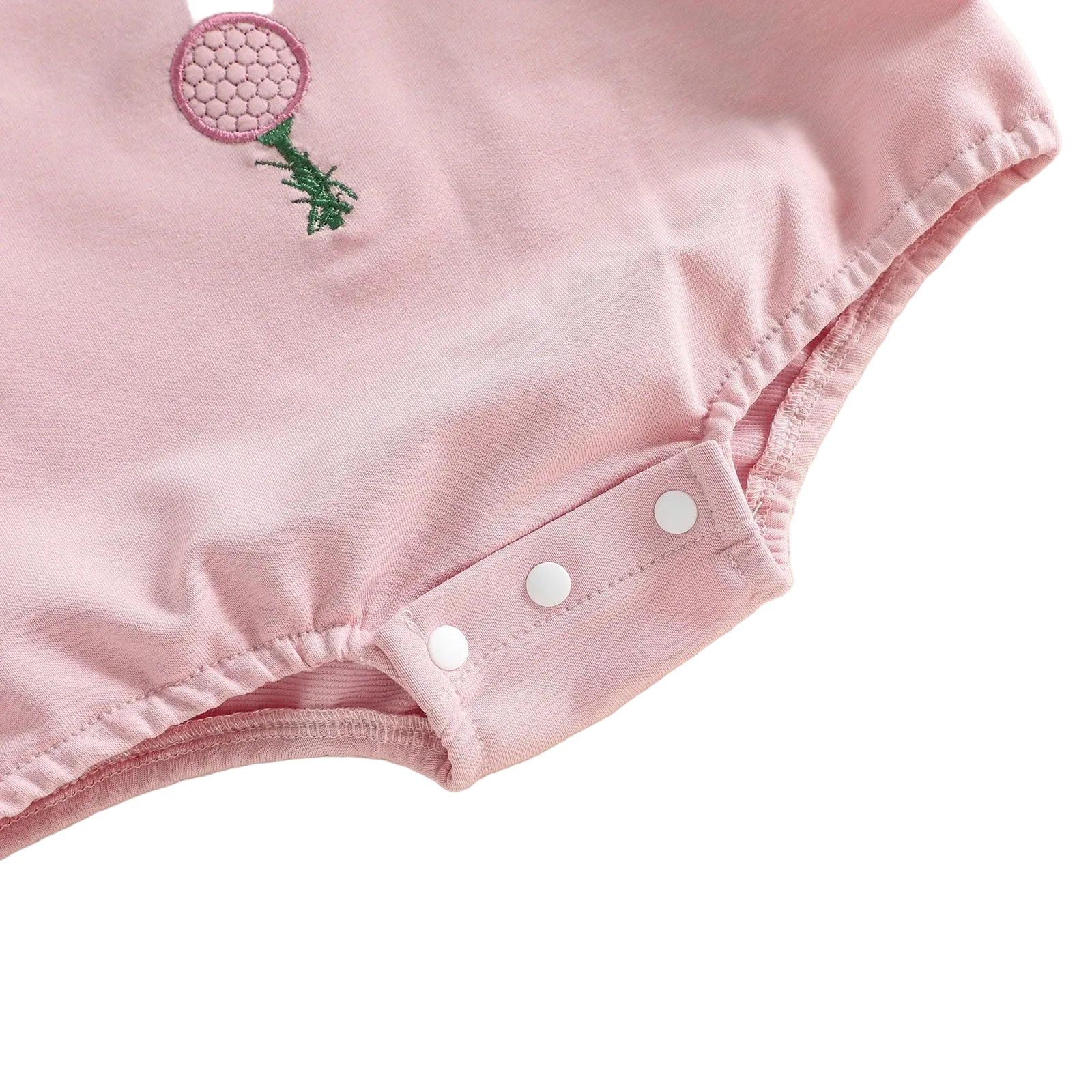 Close-up of the convenient bottom snap closures and gathered bubble-style leg openings on the pink baby romper.