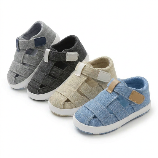 Four pairs of soft sole baby canvas summer sandals in light gray, dark gray, tan, and blue lined up together.