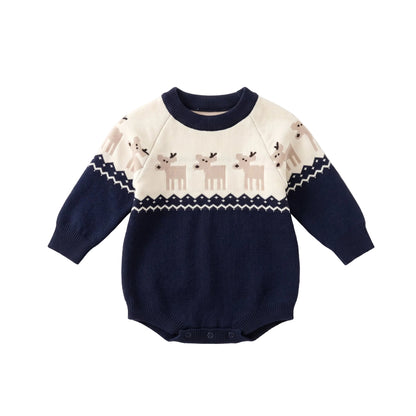 Flat lay of a navy blue and white baby Christmas knit romper featuring a reindeer pattern and long sleeves.