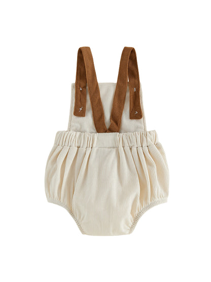 Back view of the infant bubble romper showing the cross-back style brown ribbed straps and the gathered elastic waist design.