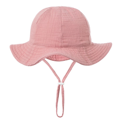Pink baby cotton sun bucket hat with wide brim and adjustable chin strap for infants and toddlers (3-18M).