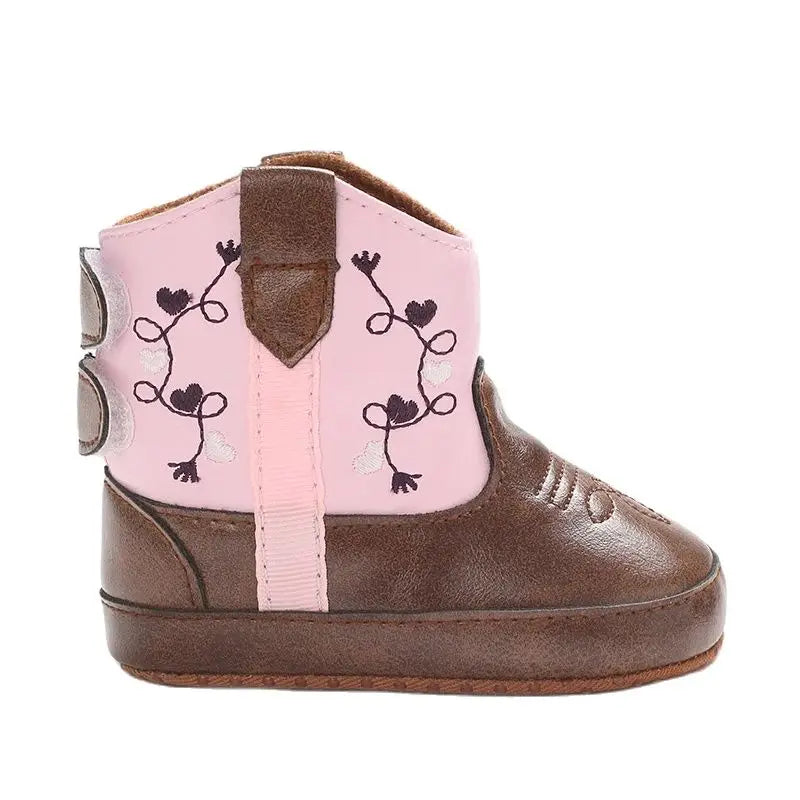 Level side view of a baby cowboy boot highlighting the flat, flexible rubber outsole.