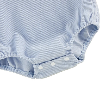 Close-up view of the gathered elastic leg openings and three white plastic bottom snap closures on an infant bubble romper.