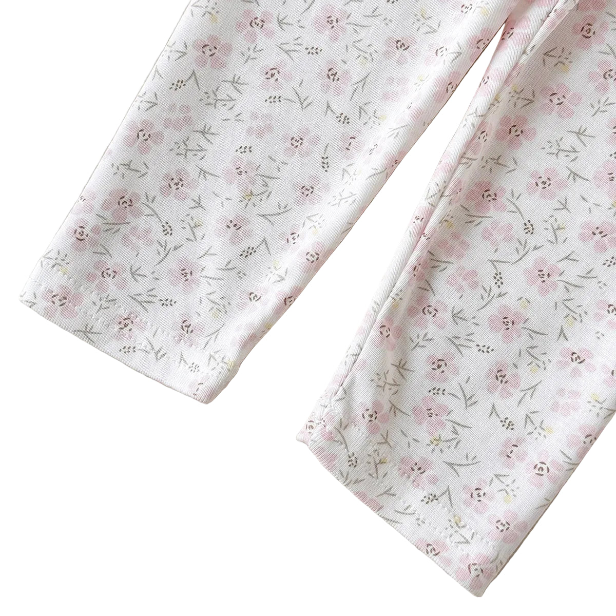 Close-up of the clean hem stitch lines at the ankle openings of the girls' floral print knit leggings.