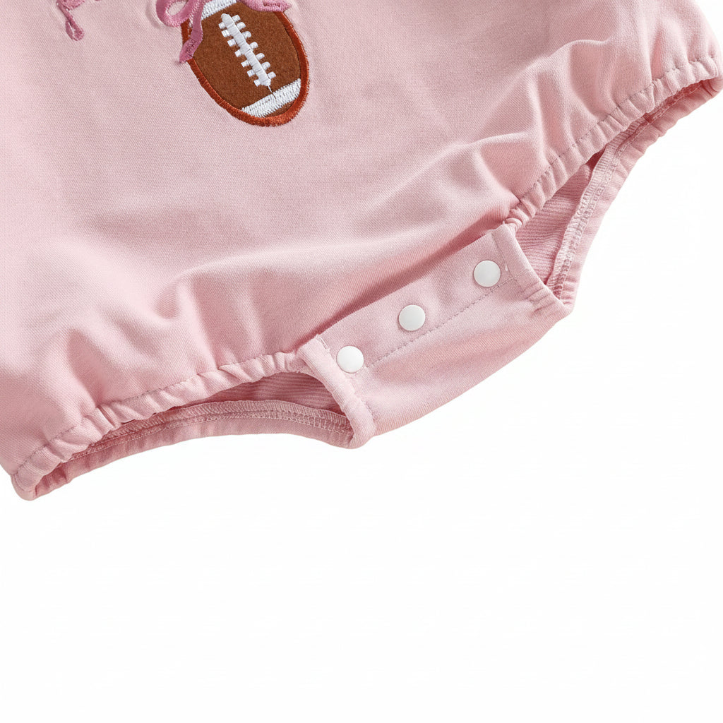 Close-up showing the convenient bottom snap closure at the crotch of the pink baby girl bubble romper.