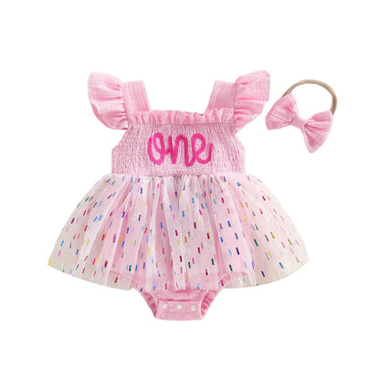 Front view flat lay of the pink 1st birthday confetti tutu romper and headband set.