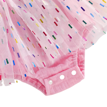 Close up showing the convenient bottom crotch snaps and colorful confetti tulle on the baby girl birthday romper.