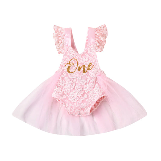 Baby girl pink lace tulle 1st birthday romper with gold glitter "One" print and fairy-style tutu skirt.