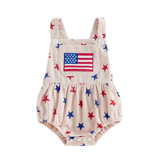 Front view of a light pink baby girl sleeveless corduroy romper featuring an all-over red and blue star print and an embroidered American flag patch on the front pocket, shown on a clean white background.