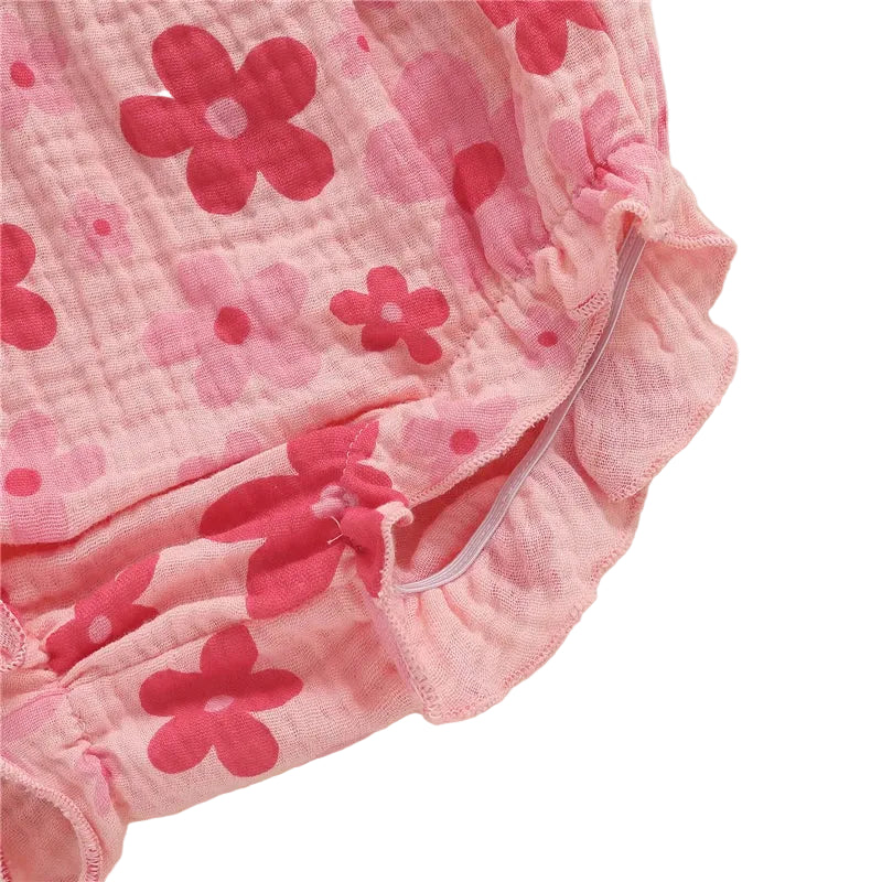 Detailed view of the ruffle trim and flexible elastic leg opening on the pink floral baby girl bloomers diaper cover.