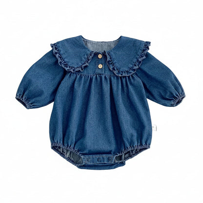 Baby girl blue denim romper with long sleeves and a ruffle Peter Pan collar displayed flat on a white background.
