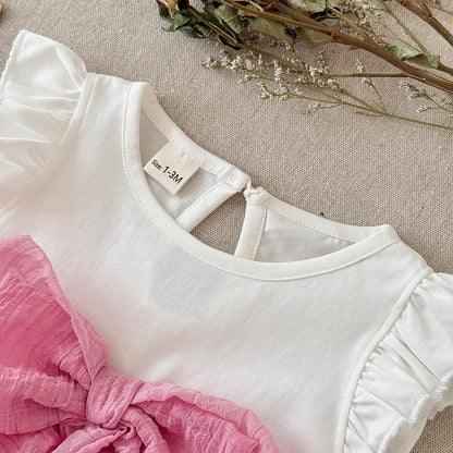 Close-up view of the white bodysuit's crew neckline, rear keyhole button closure, ruffle shoulder details, and the textured pink front bow.