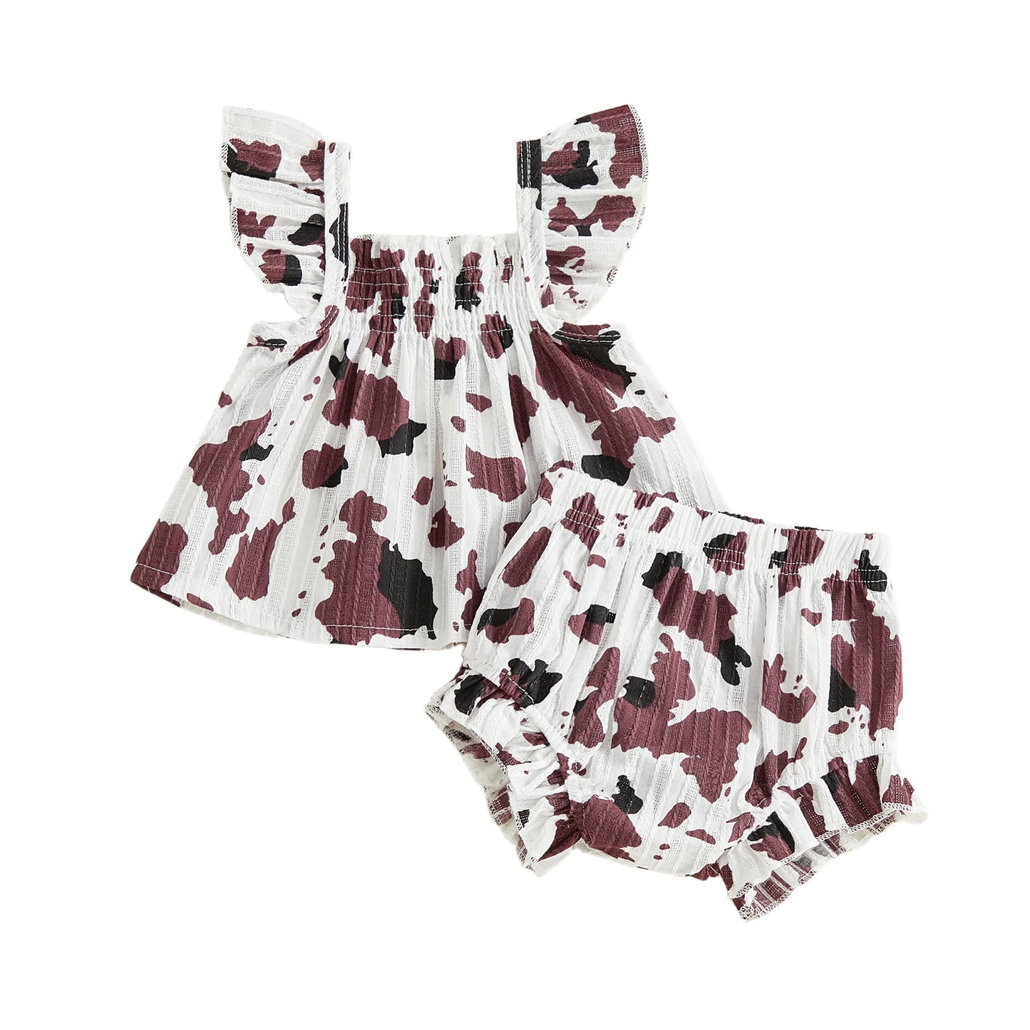Isolated flat lay of the brown and white cow print baby girl two-piece summer set showing the top and shorts.