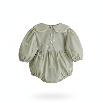 Back view flat lay of the sage green infant romper showing the secure white button placket closure.