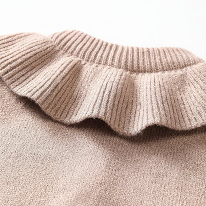 Close-up of the wide ribbed ruffle collar and white button-front closure on a taupe baby cardigan sweater.