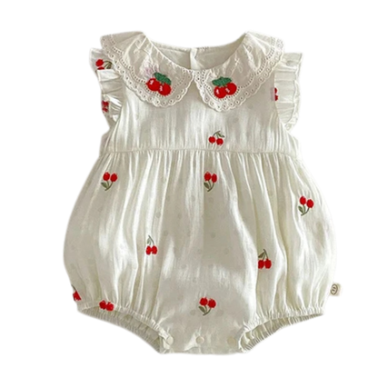 Sleeveless antique cream baby girl bubble romper with red cherry sprig embroidery, a ruffled lace Peter Pan collar, and functional bottom snaps for diaper changes.