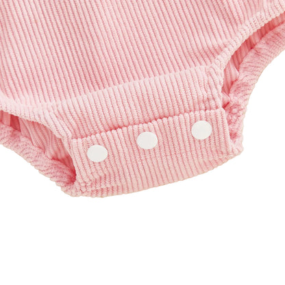 Close-up view of bottom snap closures on pink corduroy baby bodysuit romper