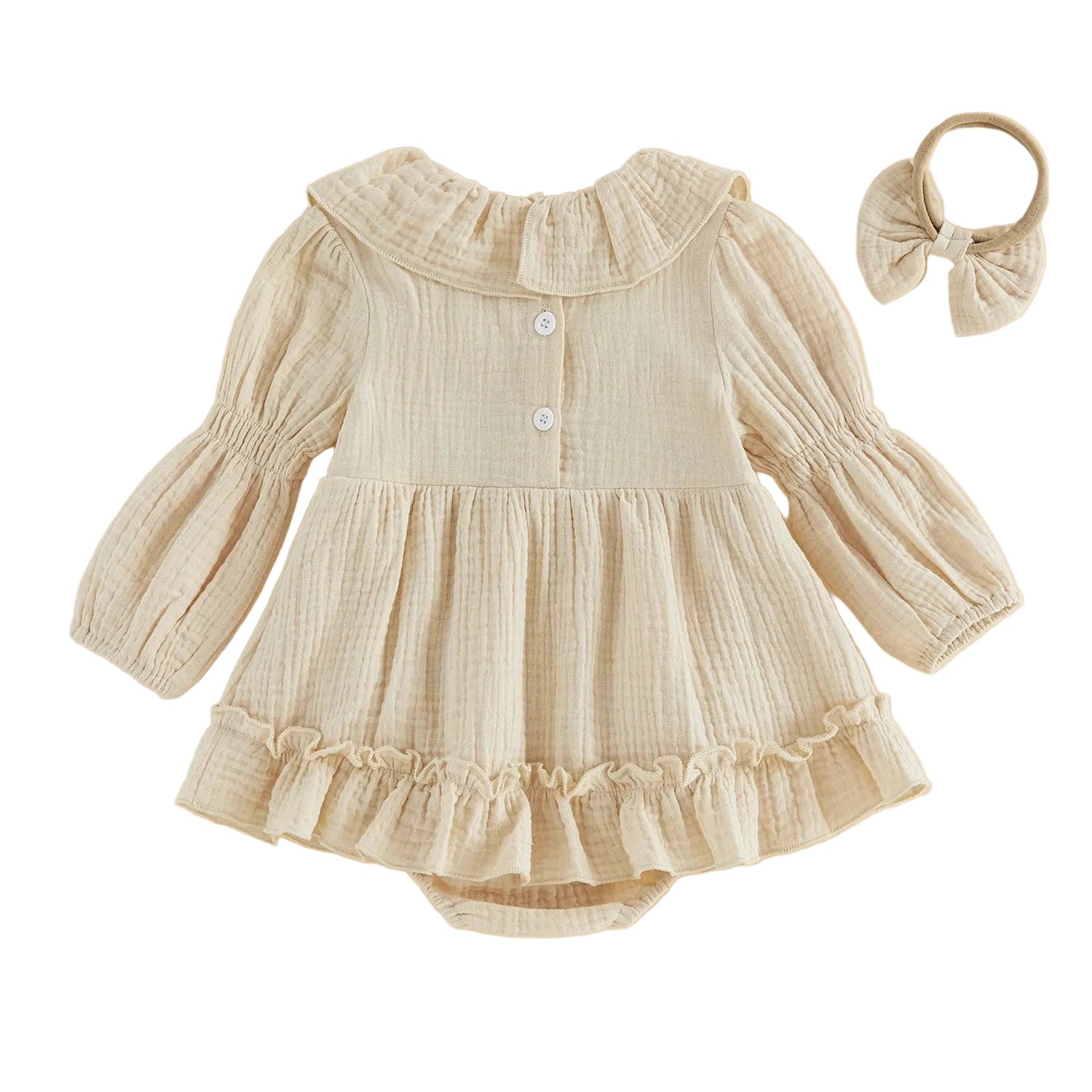 Back view of the baby girl cream long-sleeve smocked romper showing the top button closure and flared skirt, displayed with the matching headband.