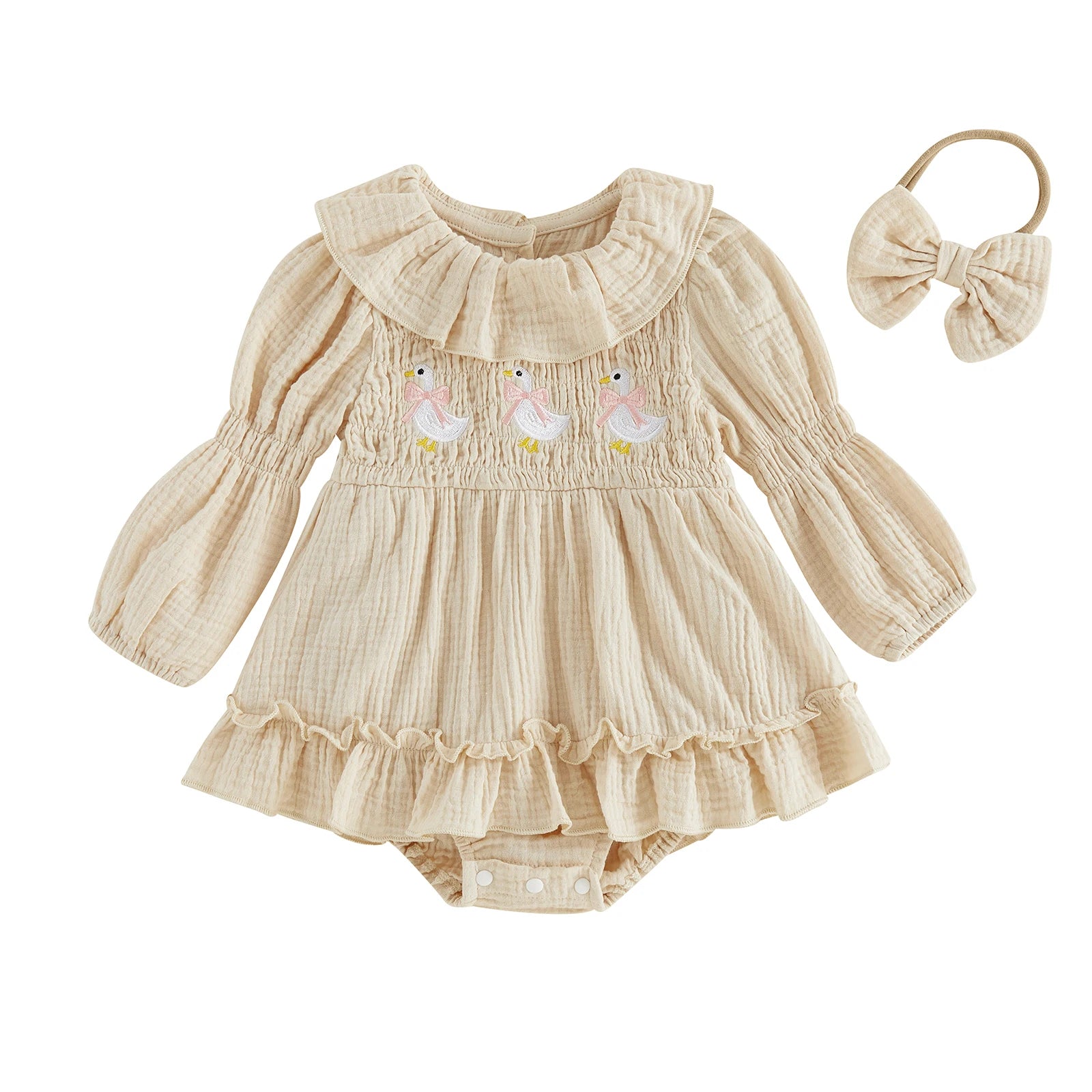 Front view of a baby girl cream long-sleeve smocked romper dress with goose embroidery and a matching bow headband on a white background.