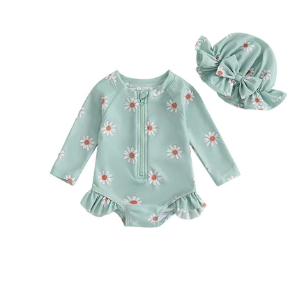Sage green toddler girl long sleeve floral bathing suit with white daisies and matching green sun hat with bow detail.