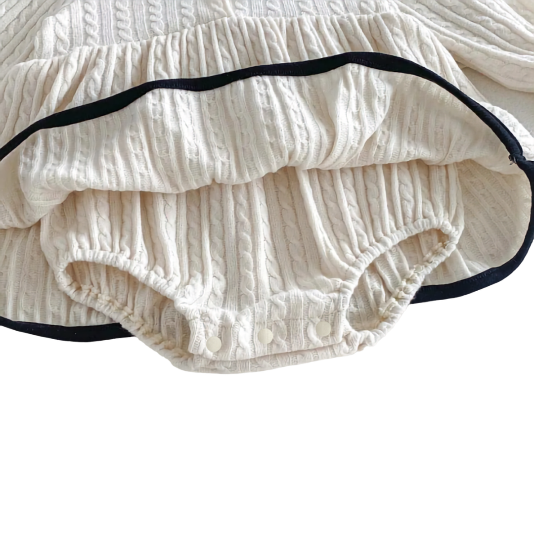 Detailed angled view of the soft material and secure snaps on the hidden bodysuit of the ivory dress.