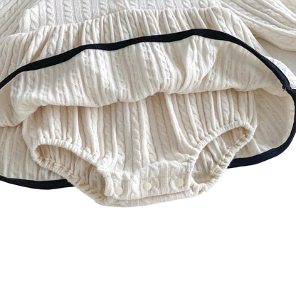 Detailed angled view of the soft material and secure snaps on the hidden bodysuit of the ivory dress.