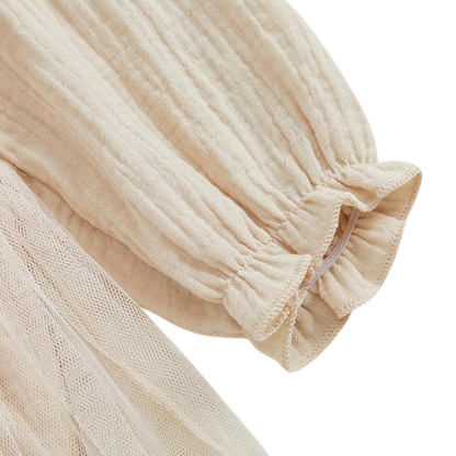 Close up of cream long sleeve with elastic cuff on baby girl smocked birthday dress