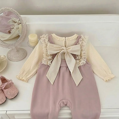 Back view of the dusty pink ribbed lace ruffle romper set showing the scoop back and large attached decorative bow