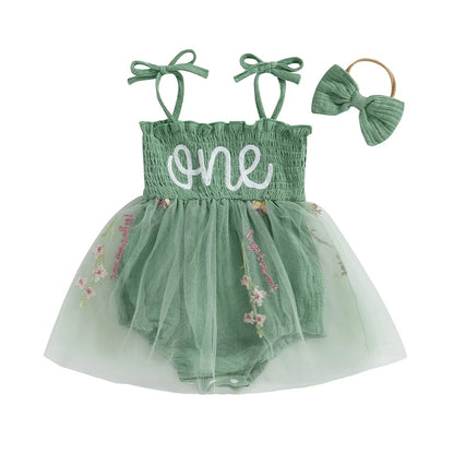 Premium sage green baby girl fairy first birthday romper set with white "one" embroidery, floral tulle tutu skirt, and matching bow headband on a clean white background.