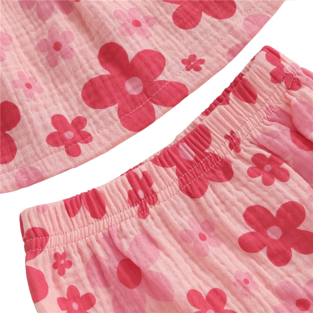 Close-up texture detail of the pink floral baby bloomers diaper cover showing the soft elastic waistband and premium crinkle muslin cotton fabric.