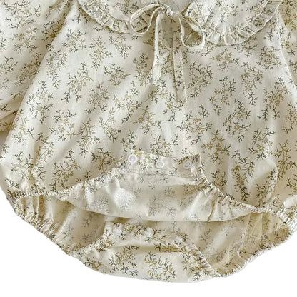 Close-up of the bottom reinforced snap buttons for easy diaper changes on the Kidsely cotton baby girl romper.