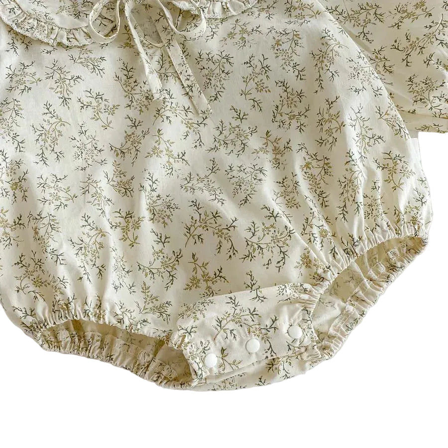 Detail shot of the gathered elastic leg opening on the Kidsely floral baby girl bubble romper.