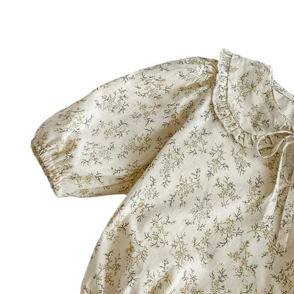 Close-up view of the long sleeve and elasticized cuff on the Kidsely sage wildflower cream cotton baby bodysuit.