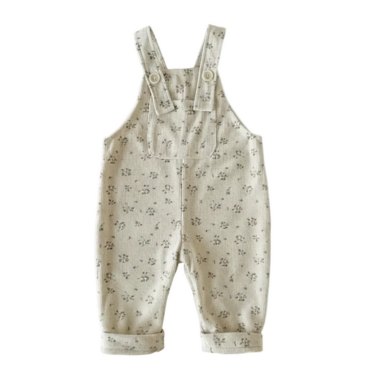 Full front view of baby girl cream floral corduroy overalls on a plain white background.