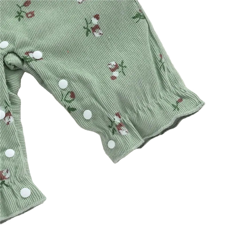 Close-up of the ruffled ankle cuffs and crotch snap button closures on the sage green baby romper.