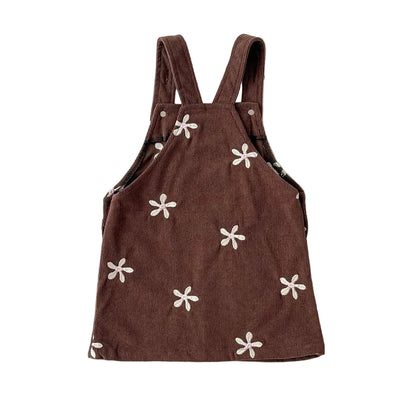 Back view showing shoulder straps and floral embroidery details on the brown corduroy dress.