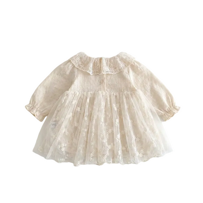 Back view of the vintage-inspired cream baby girl lace dress on a white background, highlighting the single button neckline closure, elastic ruffled sleeve cuffs, and floral embroidered tulle skirt.