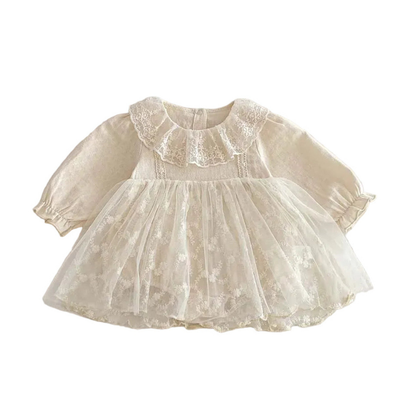 Front view of the vintage-inspired cream baby girl dress featuring a ruffled lace collar and floral tulle skirt on a white background.
